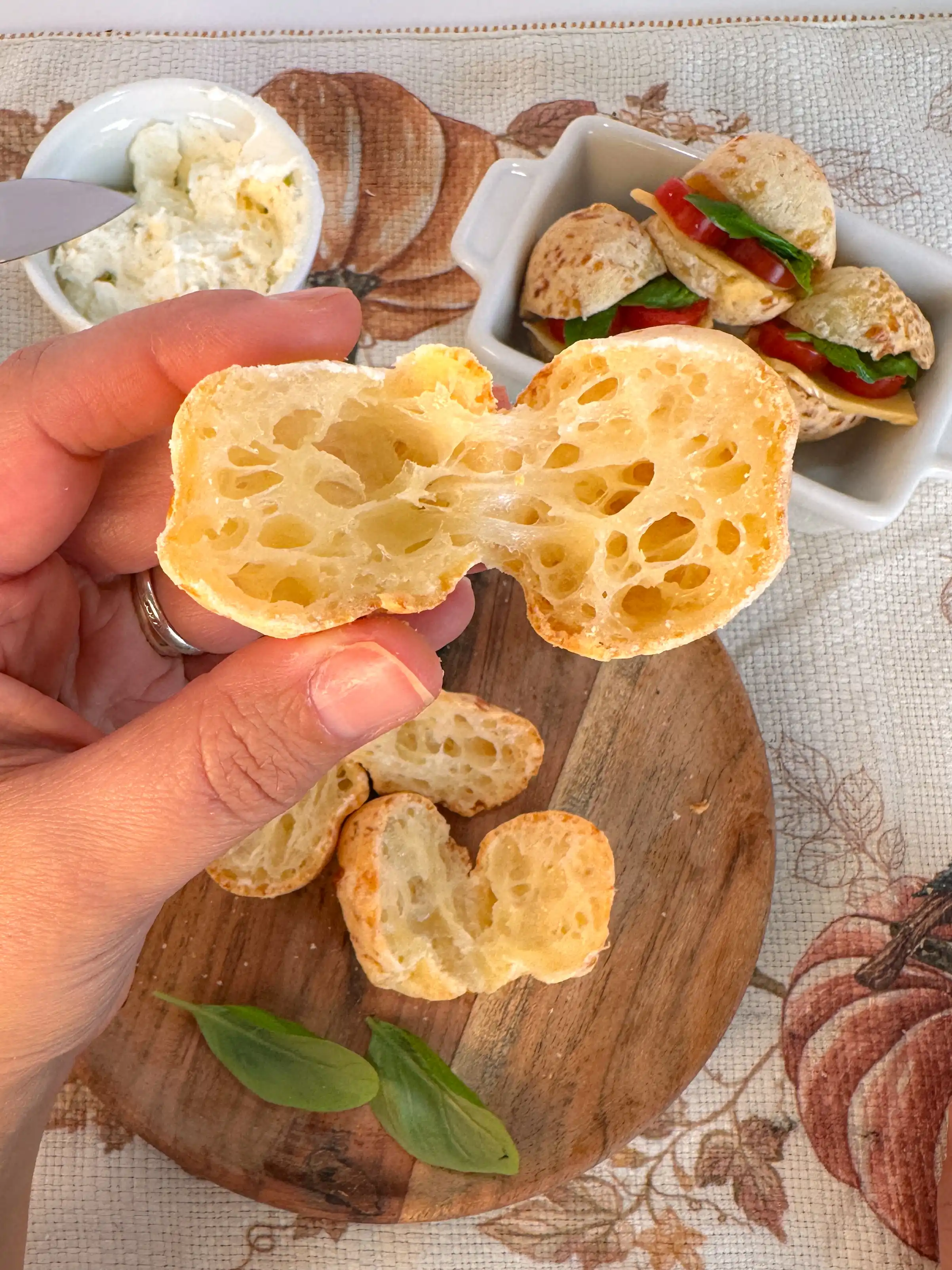 Close view of the lightly golden shell and airy, chewy center of pão de queijo